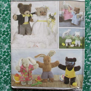 May include: A sewing pattern featuring various stuffed animal designs. The image shows teddy bears and rabbits dressed in different outfits, including wedding attire, pajamas, and beachwear. The pattern includes instructions for creating these plush toys.