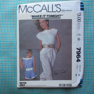 May include: A McCall's sewing pattern for a jumpsuit, with a white jumpsuit on a model and a blue jumpsuit on a smaller model. The pattern number is 7964 and the size is 12. The pattern is for a petite size and is called "Make It Tonight".