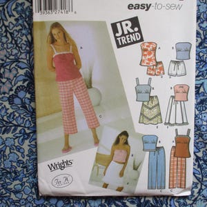 May include: A sewing pattern for women's sleepwear. The pattern features a pink top and plaid pants, along with other sleepwear designs. The package has the text "easy-to-sew" and "JR. TREND".