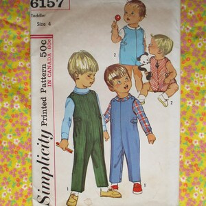 May include: Simplicity Printed Pattern 50c in Canada 80c. Sewing pattern for toddler overalls. The pattern shows three children wearing different styles of overalls. One child is holding a lollipop.