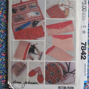 May include: A sewing pattern for a red and white envelope-style bag. The pattern includes instructions for making a round bag, a small pouch, and a larger bag with multiple compartments. The pattern number is 7842.