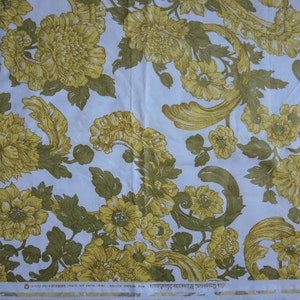 May include: White fabric with a repeating pattern of yellow floral designs. The floral pattern features stylized leaves and flowers with a vintage aesthetic.