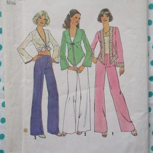 May include: Vintage sewing pattern featuring three women's outfits. The illustrations depict flared pantsuits in white, pink, and purple. The outfits include a white tie-front top, a green jacket, and a pink jacket with decorative trim. The pattern is labeled "Miss".