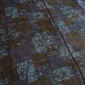 May include: A brown and purple patterned fabric with a geometric design. The fabric has a subtle sheen and a soft texture.