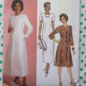 May include: A vintage sewing pattern featuring three different dress designs. One is a long, white coat dress, and the others are a white dress and a patterned coat dress. The background is a light pink color.