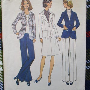 May include: Vintage sewing pattern featuring three women's suit designs. The illustrations showcase a houndstooth blazer with blue pants, a white suit with a skirt, and a navy blazer with white pants. The outfits are from the 1970s.