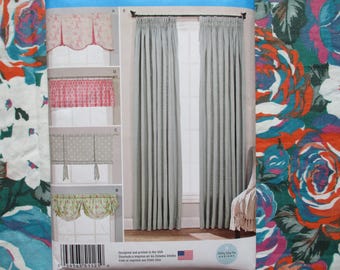 May include: The image shows a window with light grey curtains and several curtain valance designs. The valances include floral, polka dot, and patterned styles. A floral fabric with large red, blue, and white flowers is also visible.