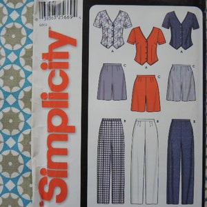 May include: Simplicity sewing pattern with a white background and red text. The pattern includes instructions for making a variety of tops and trousers. The tops include a white top with a floral pattern, a red top with a V-neck, and a blue top with a V-neck. The trousers include a pair of white trousers, a pair of red trousers, a pair of blue trousers, and a pair of plaid trousers.