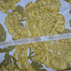May include: A white fabric with a yellow floral pattern. The fabric has a label that reads "An Original Waverly Fabric Bolton Manor".