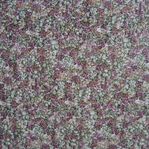 May include: A close-up of a fabric with a small-scale floral pattern. The fabric is a mix of white, pink, and green.