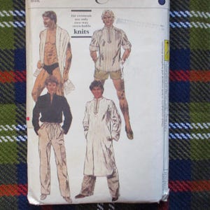 May include: Vintage sewing pattern featuring illustrations of men's clothing designs. The pattern includes images of a swimsuit, a striped shirt with shorts, a black shirt with pants, and a long white tunic with pants. The text on the pattern reads "for swimsuit use only two-way stretchable knits."