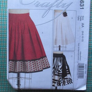 May include: A sewing pattern for a skirt with three different styles. The pattern is for sizes AA (6-8-10-12). The pattern is called "Crafty" and the pattern number is 631.