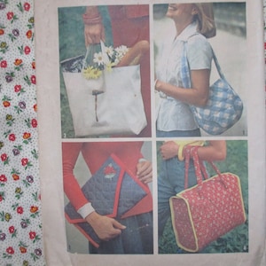 May include: A sewing pattern for making different types of bags. The pattern includes instructions for making a tote bag, a satchel bag, and a small clutch bag. The bags are all made from fabric and have a quilted design.