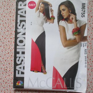 May include: A sewing pattern for a dress with a white, black, and red color scheme. The pattern is labeled "Fashion Star" and "McCalls" and includes the size "AX5 (14-6-8-10-12)".