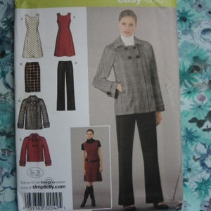 May include: A sewing pattern for a double-breasted jacket, skirt, and blouse. The pattern includes a black and white plaid jacket, a black skirt, and a white blouse with a red trim. The pattern is from Simplicity.com.