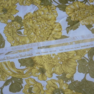 May include: A white fabric with a yellow floral pattern. The fabric has a label that reads "An Original Waverly Slesheen 100% Combed Cotton Color styled with Du Pont SAVALLUX Test Colors".