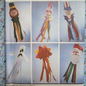 May include: A set of six colourful felt windsock patterns. The windsocks feature a variety of characters, including a leprechaun, a bunny, Uncle Sam, a ghost, a star, and Santa Claus. Each pattern includes instructions for creating the windsock.