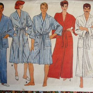 May include: A sewing pattern for four robes. The pattern includes a blue robe with a sash, a striped robe with a sash, a red robe with a sash, and a white robe with a sash. The pattern is labeled "Classics".