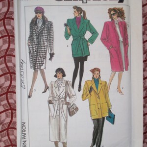 May include: A sewing pattern for four different coats. The coats are in a variety of colors and styles, including a black and white houndstooth coat, a green coat with a belt, a pink coat, and a yellow coat. The pattern is from Simplicity and is number 8707.