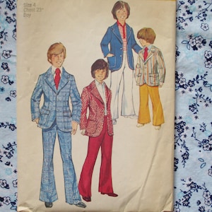 May include: A vintage sewing pattern for boys' clothing. The pattern includes three different styles of jackets and pants. The text on the pattern reads "Size 4 Chest 23" Boy".