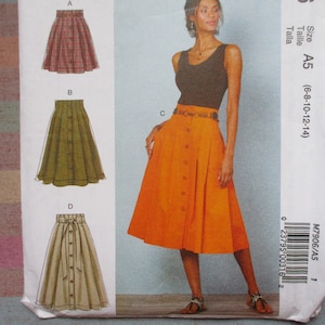 May include: A sewing pattern for four different skirts. The skirts are all knee-length and have a button-up front. The pattern includes sizes 6-8-10-12-14. The pattern is called M7906/A5.