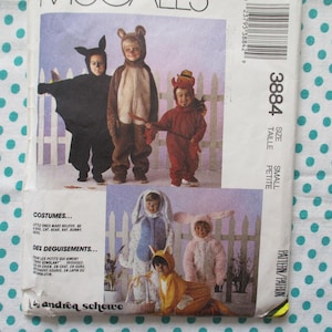 May include: A vintage sewing pattern featuring children in various costumes, including a bat, bear, and devil. The pattern includes the text "COSTUMES..." and "DES DEGUISEMENTS..." with the number "3884" and the size "SMALL".