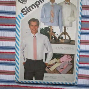 May include: A sewing pattern for a men's shirt with a long sleeve and a tie. The pattern is from Simplicity and designed by Henry Grethel. The pattern includes a special chart on how to work with pleats.