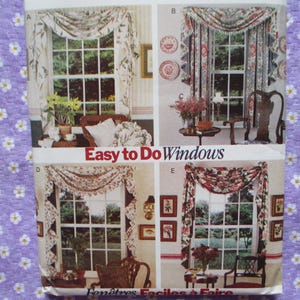May include: A multi-panel image displaying window treatment designs. The designs feature floral patterned valances and curtains. The text "Easy to Do Windows" is visible. The background is a purple fabric with white daisy patterns.