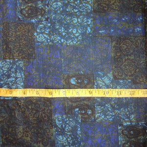 May include: Blue and brown patterned fabric with a ruler measuring 15 inches.