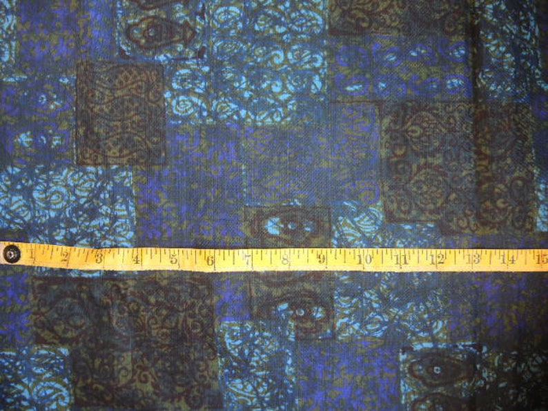 May include: Blue and brown patterned fabric with a ruler measuring 15 inches.
