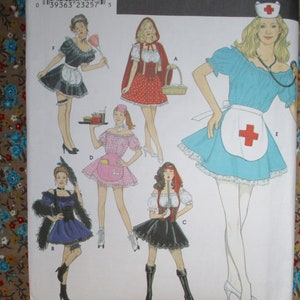 May include: A sewing pattern for five different costumes: a maid, a red riding hood, a waitress, a pirate, and a nurse. The pattern includes instructions and diagrams for each costume.
