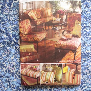 May include: An image of outdoor furniture with floral and striped patterns. The set includes a sofa, chairs, and a bench, all with metal frames. The cushions feature a mix of floral and striped designs, creating a cohesive look for a patio or outdoor space.