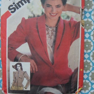May include: A red blazer with a collar and a button closure. The blazer has a long sleeve and a fitted silhouette. The model is wearing a white shirt underneath the blazer.