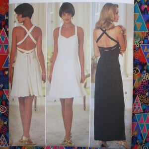 May include: Three different styles of a white and black dress with a criss-cross back design. The dresses are sleeveless and have a scoop neckline. The white dress is shorter and has a bow at the back. The black dress is longer and has a more fitted silhouette.