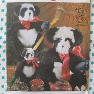 May include: Image of a panda bear plush toy with black and white fur, a red bow, and a small teapot. The image also includes a drawing of a panda bear with the letters "A B C".