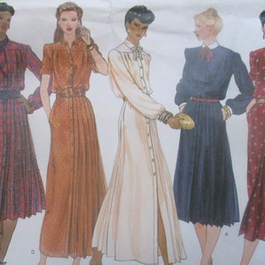 May include: A sewing pattern featuring four different dress designs. The dresses are all knee-length and have a button-up front. The dresses are in a variety of colors and patterns, including plaid, brown, white, and navy blue.