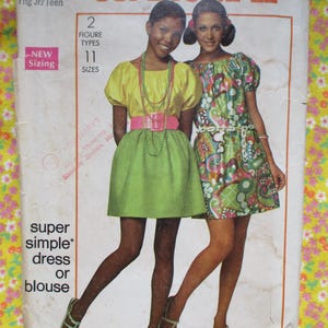 May include: Vintage sewing pattern featuring two women modeling dresses and blouses. The pattern includes "New Sizing" and offers "11 Sizes." The dresses are in bright colors, with one in yellow and green, and the other in a colorful floral print.