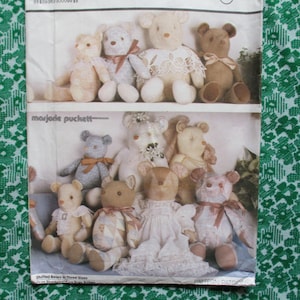 May include: A pattern sheet featuring various stuffed teddy bears in different sizes and styles. The bears are in shades of beige, brown, and white, some with ribbons and lace. The text "marjorie puckett" is visible.