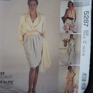 May include: A sewing pattern for a wrap skirt with a pleated front. The pattern is for sizes 10, 12, and 14. The pattern is from McCall's and is called "Easy Cut-to-Fit".