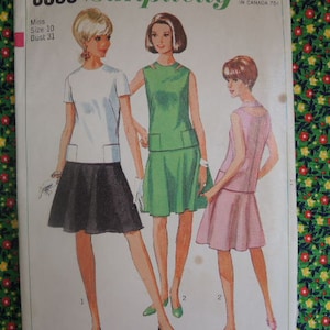 May include: A vintage sewing pattern for a dress with a white top and a black skirt, a green dress with a white top and a green skirt, and a pink dress with a white top and a pink skirt. The pattern is for size 10 with a bust measurement of 31 inches.