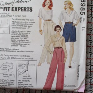 May include: A sewing pattern package with illustrations of women's clothing designs. The package includes the text "Palmer/Pletsch the FIT EXPERTS" and details for a fit pant, with size 14. The designs include trousers and shorts.