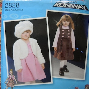 May include: A sewing pattern for a child's dress. The pattern is for a white fur-trimmed dress with a pink skirt and a brown polka dot dress with a white collar. The pattern is from Project Runway and is size A 3, 4, 5, 6, 7, 8.
