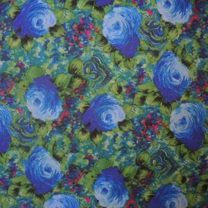 May include: A blue floral fabric with a repeating pattern of blue roses on a green background.