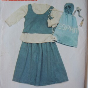 May include: A blue and white dress with a white blouse and a blue skirt. The dress has a drawstring waist and a matching blue drawstring bag with the word "ESPRIT" printed on it.
