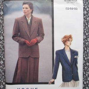 May include: A Vogue sewing pattern envelope featuring two blazer designs. One illustration shows a brown plaid blazer with a brown skirt and red gloves. The other shows a blue blazer with a white top and skirt. The text reads PATTERN/PATRON SIZE/TAILLE (12-14-16).