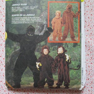 May include: A sewing pattern for making animal costumes. The pattern includes instructions for making a gorilla, monkey, and bear costume. The pattern is for adults and children. The text on the pattern reads "Jungle Fever" and "Sorti de la Jungle".