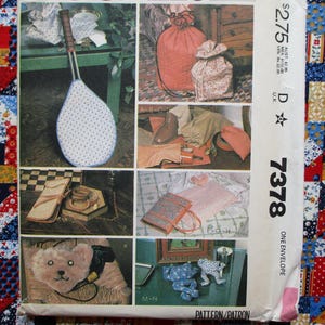 May include: A vintage sewing pattern with multiple project examples. The projects include a tennis racket cover, drawstring bags, a tote bag, and a teddy bear. The pattern is labeled with the price $2.75 and the number 7378.