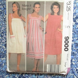May include: Vintage sewing pattern featuring three dress designs. The dresses include a white dress with pink accents, a striped dress, and a solid coral dress. The pattern is labeled "Make it Tonight" and includes sizing information.
