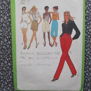 May include: Vintage sewing pattern featuring fashion illustrations of women in various outfits, including shorts, blouses, and high-waisted red pants. The pattern includes handwritten notes and measurements. The waist size is 25 inches.