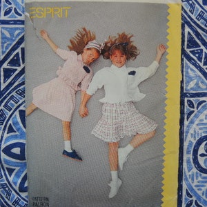 May include: A vintage sewing pattern featuring two girls wearing dresses. The pattern is from Esprit and is titled "Pattern/Patron".